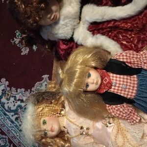 Porcelain dolls - lot of three. Girl in fur, Victorian girl, cowboy-ish girl
